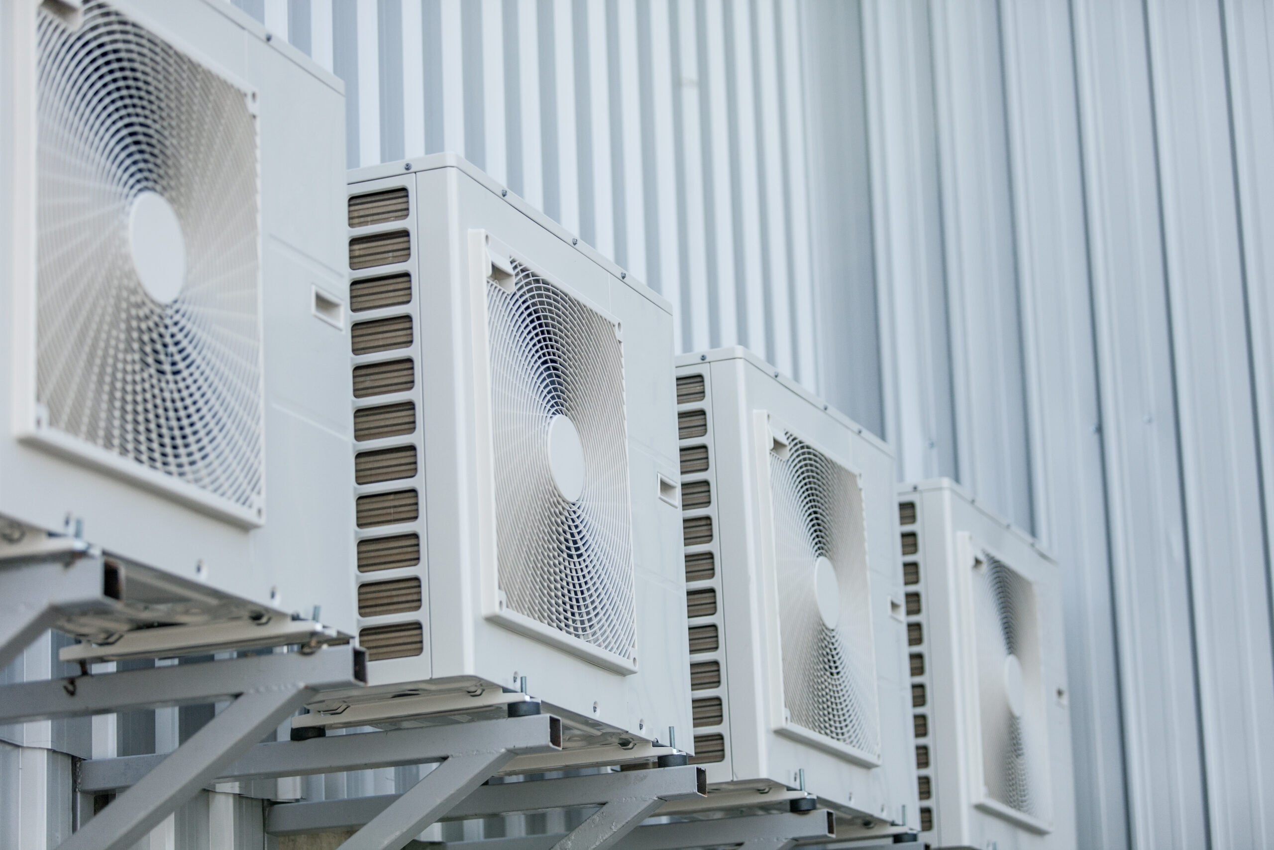 closeup of air conditioners installed on the outside wal