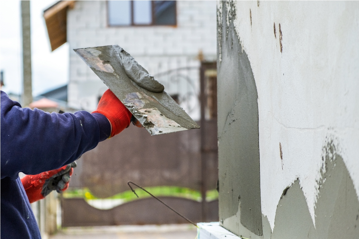 construction worker covering house wall with adhes 2023 03 22 03 35 17 utc