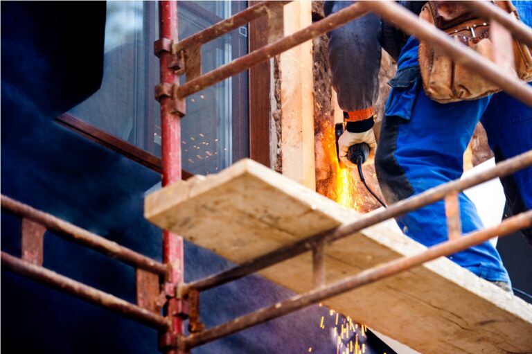 construction worker insulating house with glass wool, close up