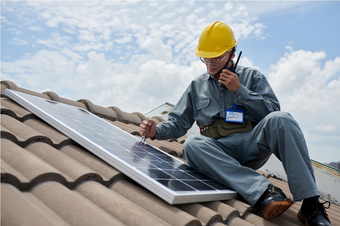 contractor installing solar panel and using with walkie talking