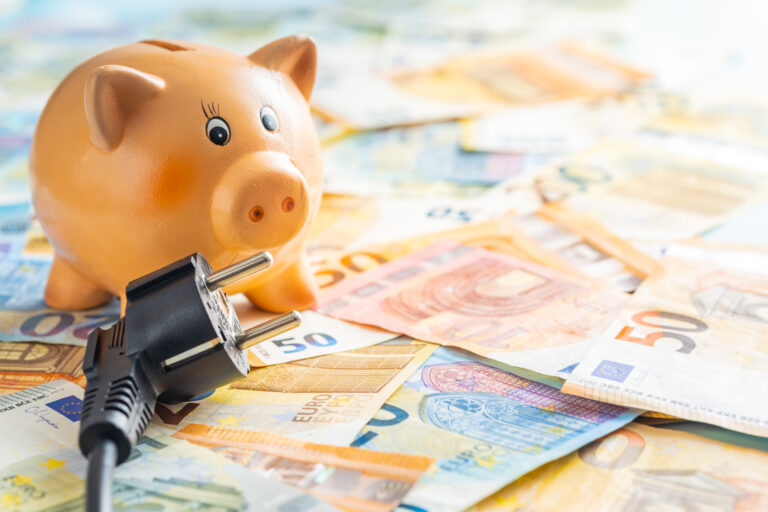 electric plug, piggy bank and euro money. concept of increasing electricity prices.