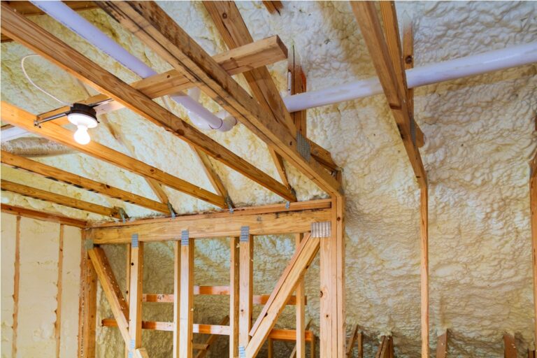foam plastic insulation installed in the sloping ceiling of a new frame house.