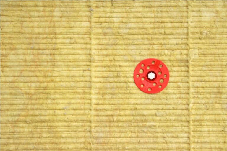 green mineral wool with dowels with red plastic caps