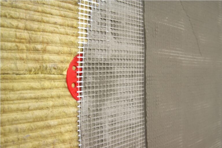 green mineral wool with dowels with red plastic caps