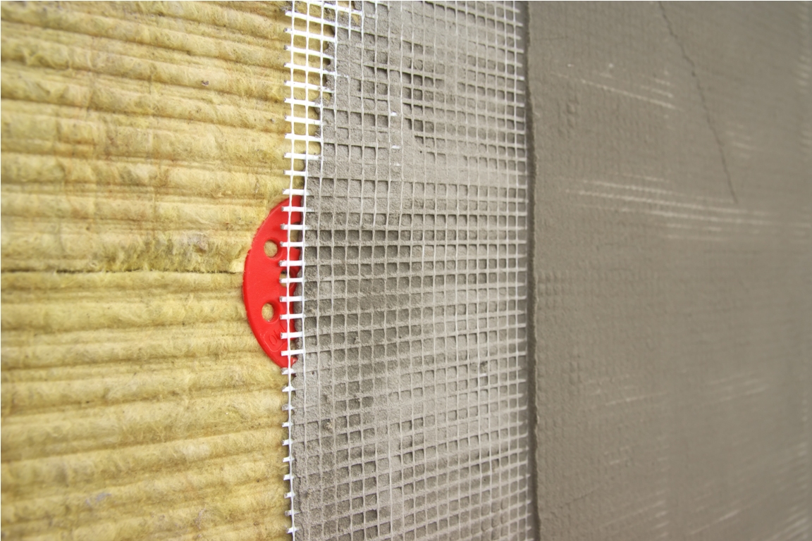 green mineral wool with dowels with red plastic caps