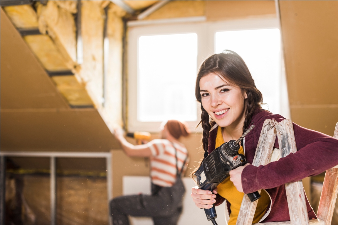 independent young woman renovating her new home