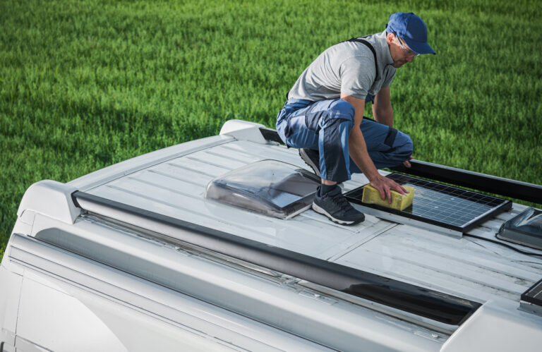 men cleaning camper van rv roof installed solar panels