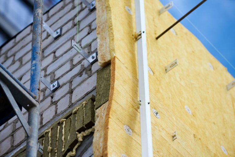office building under construction. facing and insulation of walls.