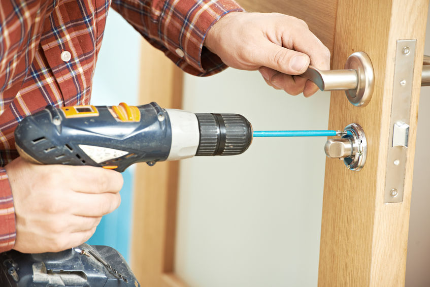 carpenter at door lock installation