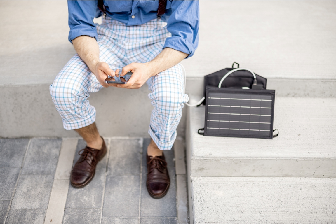 man charge phone from portable solar panel 2022 06 15 23 37 47 utc